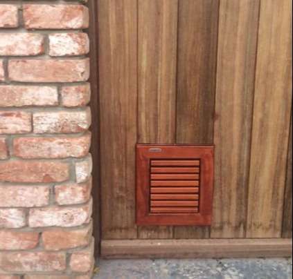 Cat Flap | Cat Door | Custom made padouk wooden cat flap installed in a solid wood door | © Tomsgates